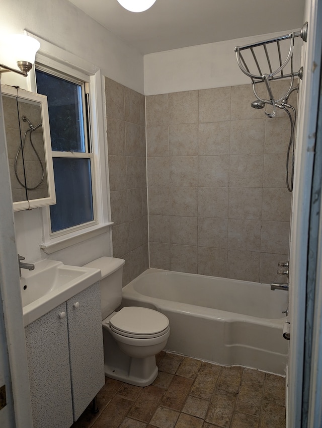 full bathroom featuring toilet, vanity, and tiled shower / bath