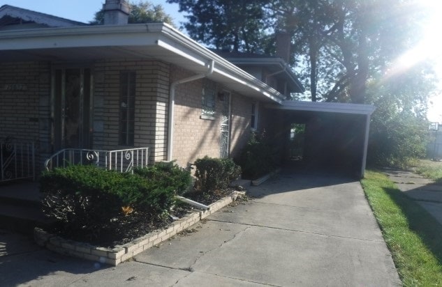 view of side of home featuring a carport