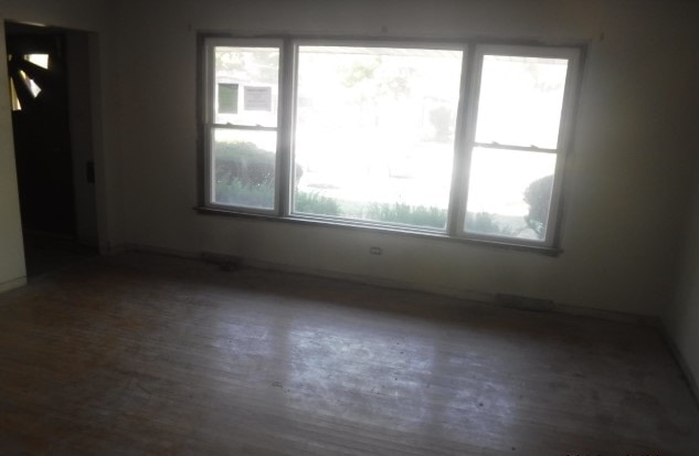 empty room with dark hardwood / wood-style flooring