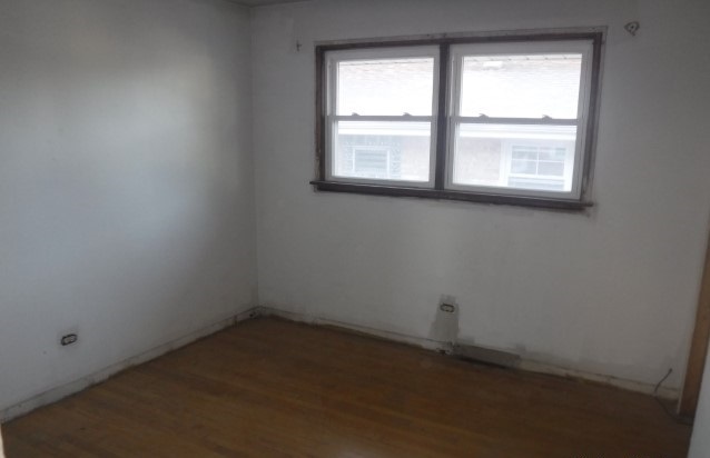 unfurnished room with hardwood / wood-style floors