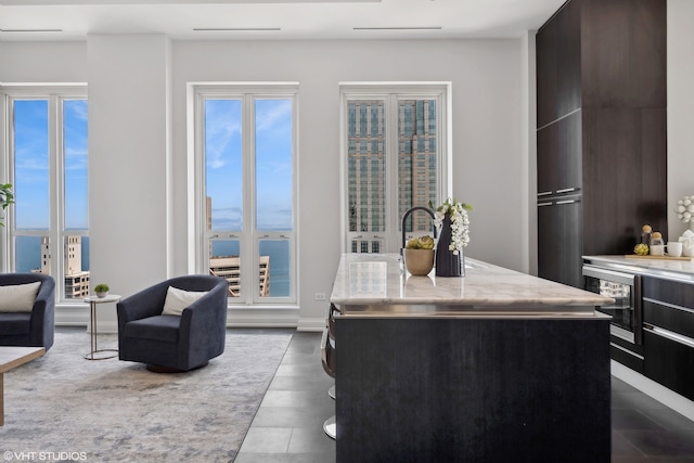 kitchen with a water view, a center island, and beverage cooler