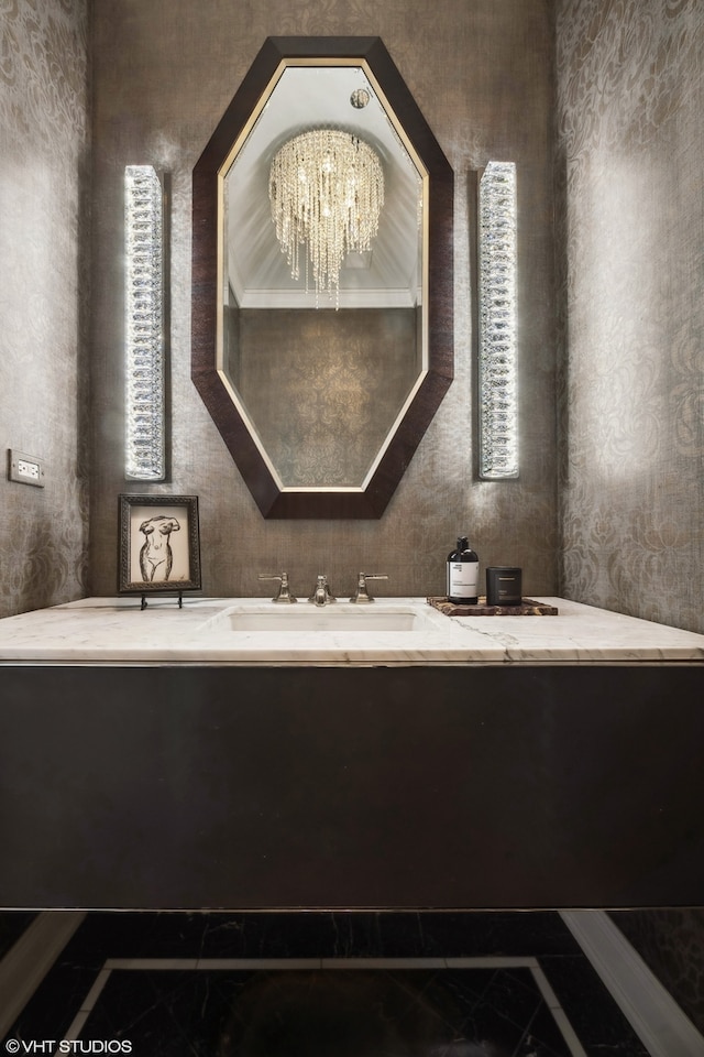 bathroom featuring tile patterned floors, sink, and an inviting chandelier