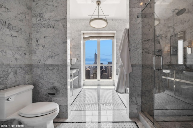 bathroom featuring tile walls, a shower with shower door, toilet, and tile patterned flooring