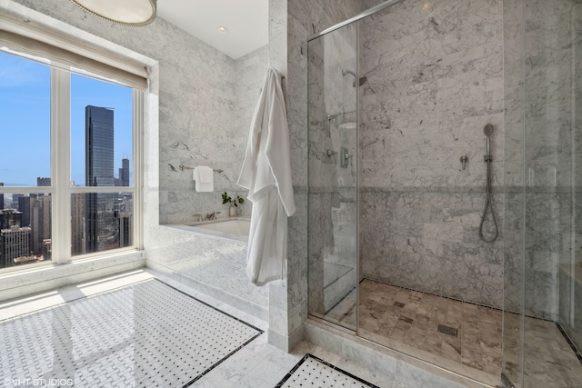 bathroom featuring separate shower and tub