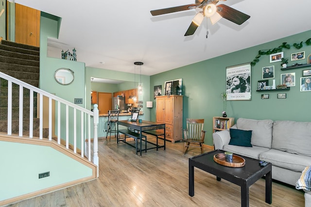 living room featuring light hardwood / wood-style floors and ceiling fan