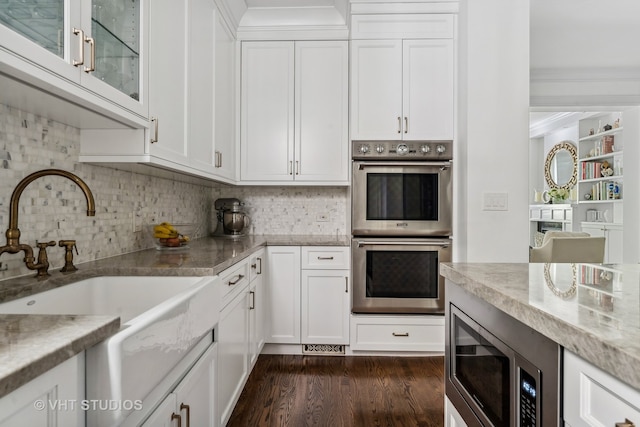 kitchen with white cabinetry, stainless steel appliances, dark hardwood / wood-style flooring, and sink