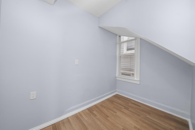 bonus room featuring hardwood / wood-style flooring and lofted ceiling