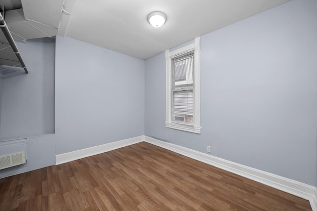 spare room featuring wood-type flooring