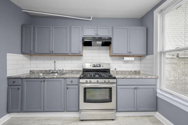 kitchen with gray cabinets, sink, range hood, and gas stove