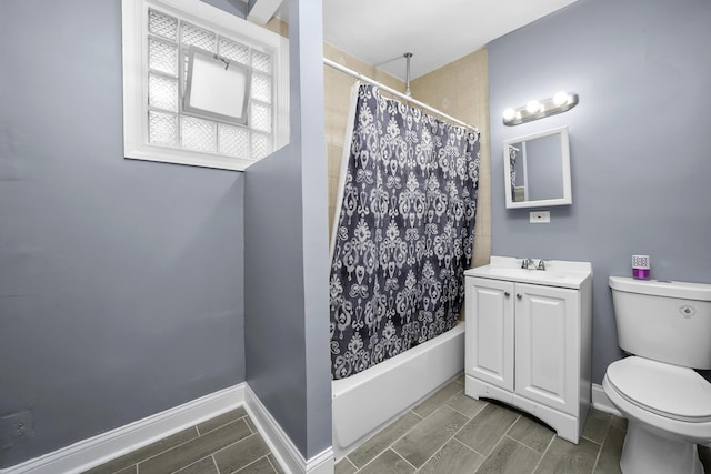 full bathroom with vanity, shower / bath combo, and toilet