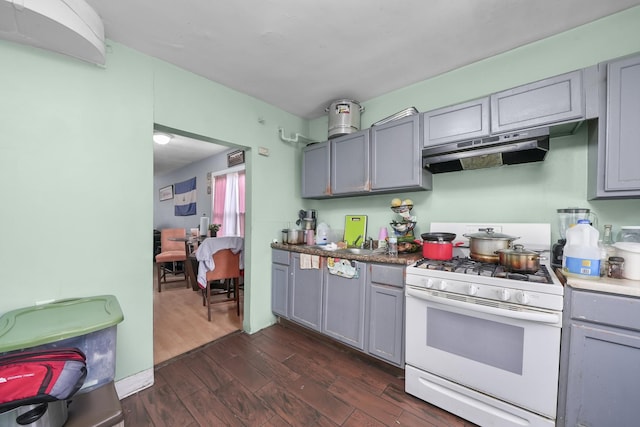 kitchen with dark hardwood / wood-style floors, white gas stove, and gray cabinetry