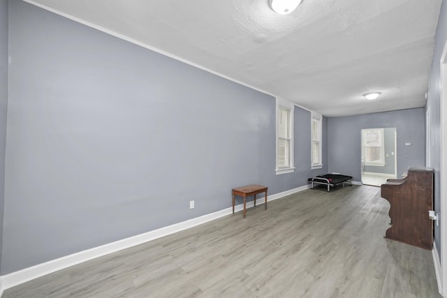 interior space featuring light hardwood / wood-style flooring and a textured ceiling