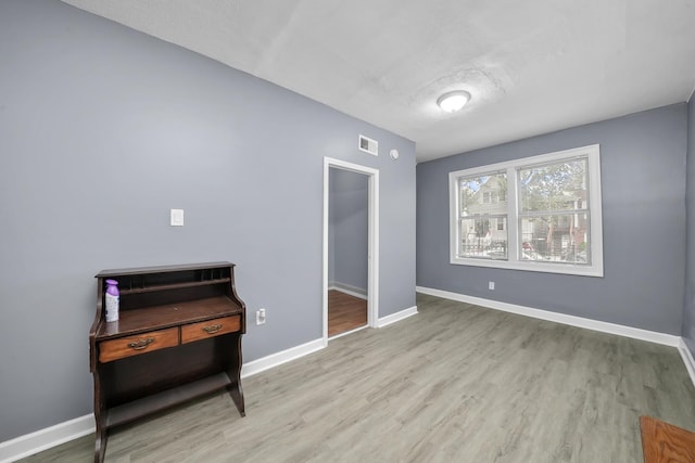 interior space with a textured ceiling and light wood-type flooring