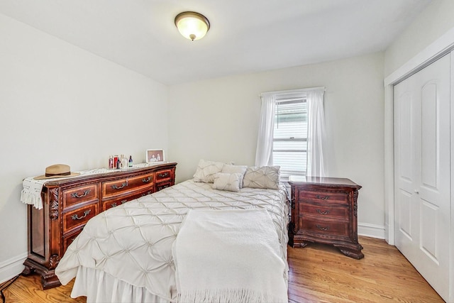 bedroom with a closet and light wood-type flooring