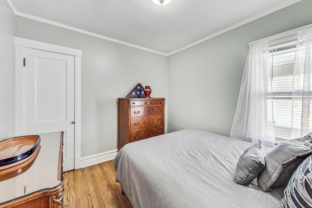 bedroom featuring ornamental molding and light hardwood / wood-style floors