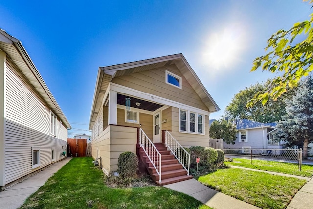 bungalow-style house with a front yard