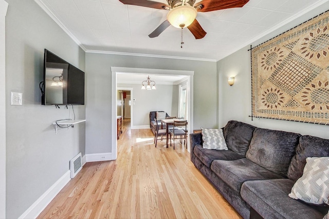 living room featuring ornamental molding, light hardwood / wood-style floors, and ceiling fan with notable chandelier