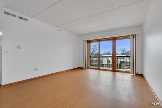 spare room featuring light hardwood / wood-style flooring