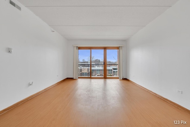 unfurnished room featuring light hardwood / wood-style floors