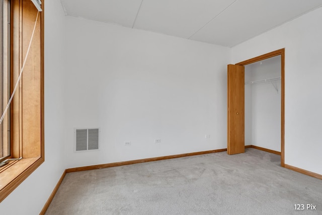 unfurnished bedroom featuring light carpet