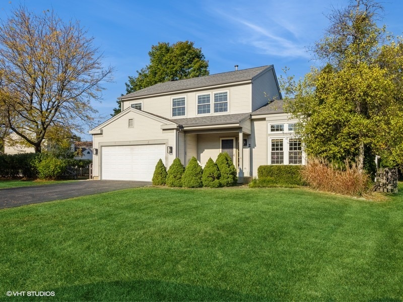 front facade featuring a garage and a front lawn