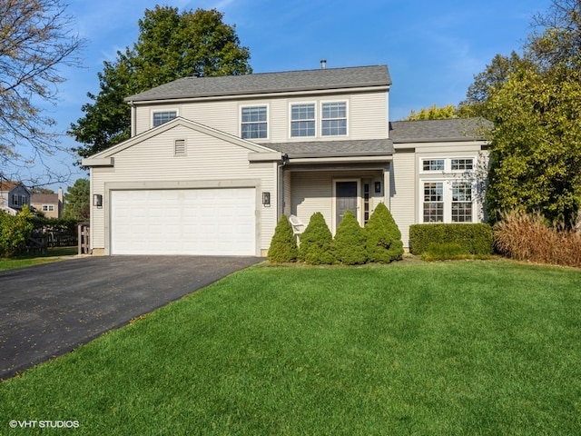 front of property featuring a front yard and a garage