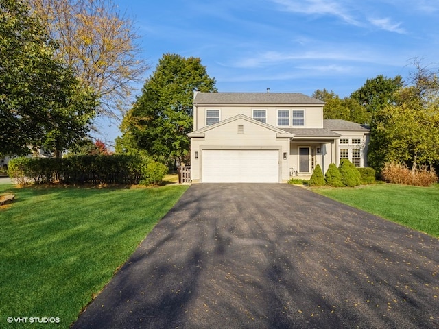 front facade with a garage and a front lawn