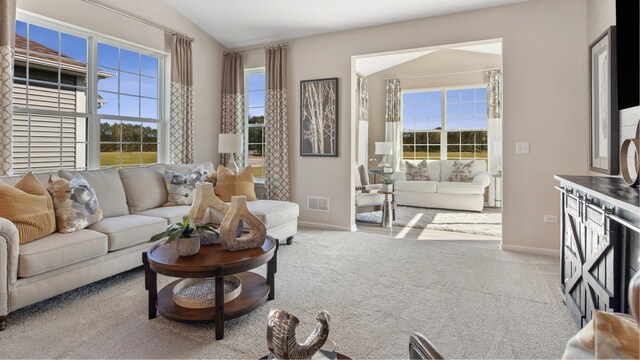 carpeted living room featuring vaulted ceiling