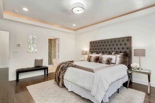 bedroom featuring a tray ceiling and dark hardwood / wood-style floors