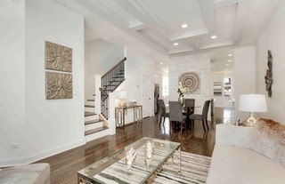 living room featuring coffered ceiling and dark hardwood / wood-style floors