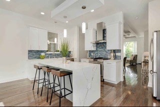 kitchen featuring white cabinets, stainless steel appliances, and extractor fan