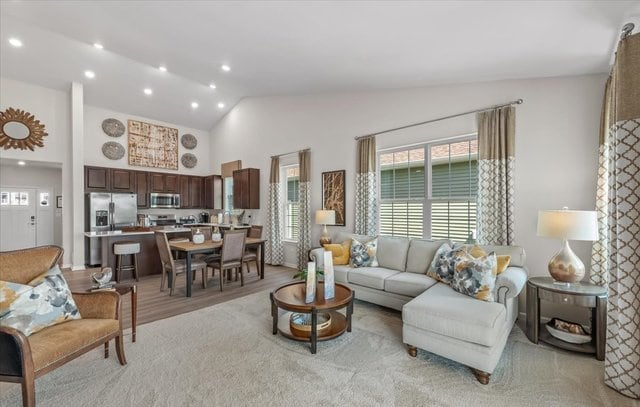 living room with lofted ceiling and light hardwood / wood-style flooring