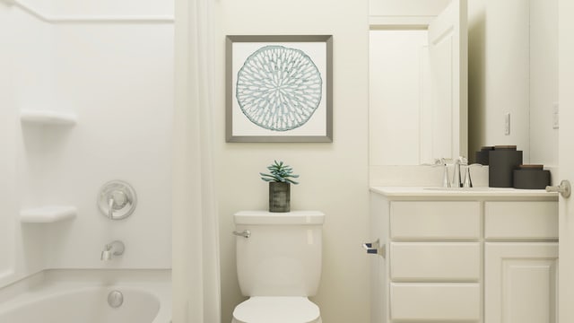 bathroom with vanity, a tub to relax in, and toilet