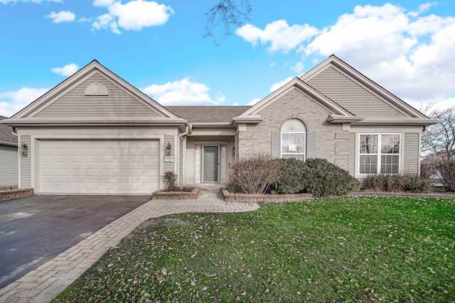 view of front of house with a front lawn and a garage