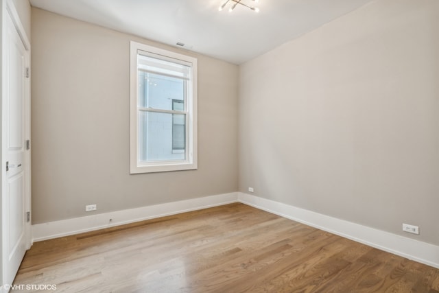 spare room featuring light hardwood / wood-style floors