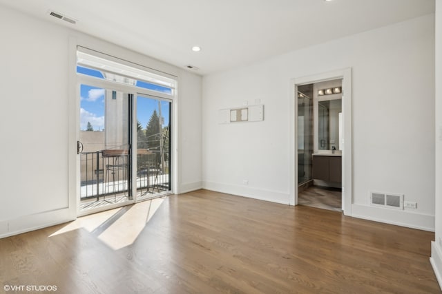 spare room with hardwood / wood-style flooring