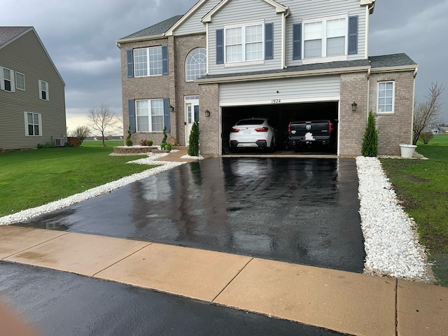 view of front of house featuring a front yard and a garage