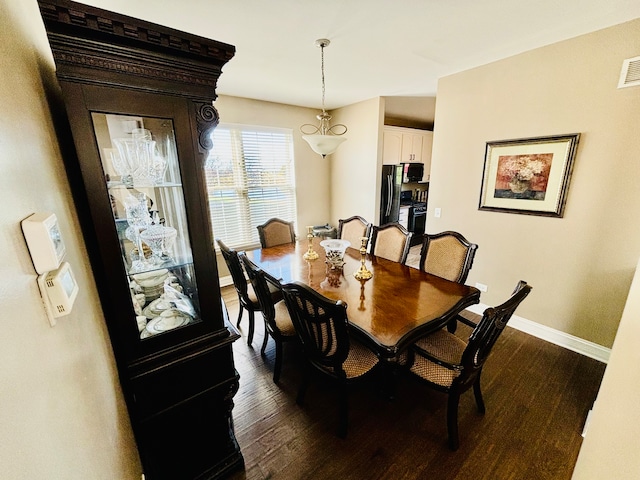 dining area with dark hardwood / wood-style flooring