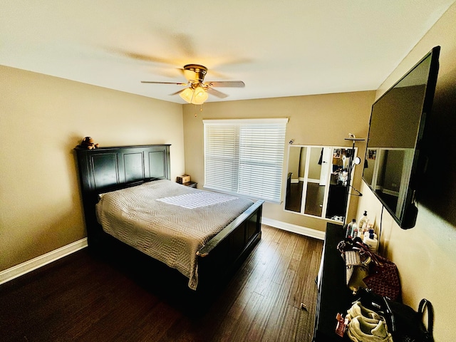 bedroom with dark hardwood / wood-style floors and ceiling fan