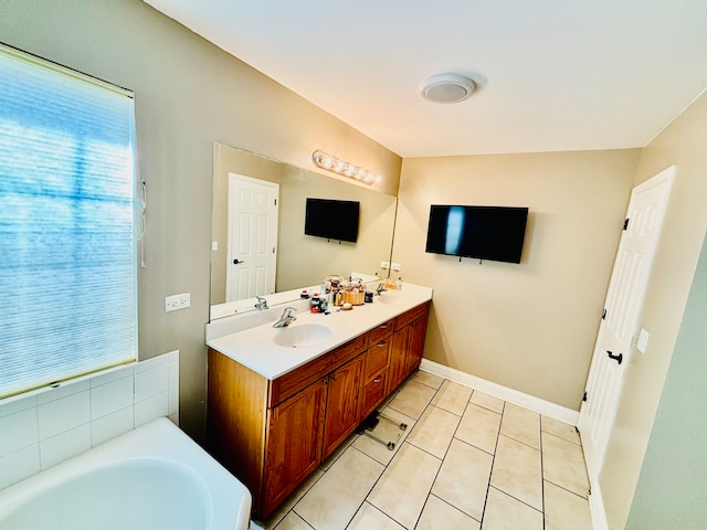 bathroom featuring vanity, tile patterned floors, and a washtub