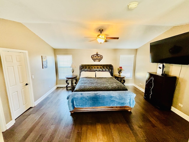 bedroom with ceiling fan, vaulted ceiling, and dark hardwood / wood-style floors