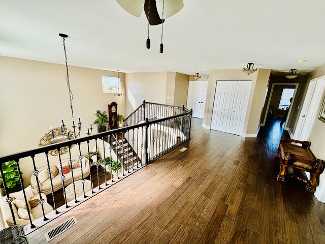 hallway featuring a notable chandelier and hardwood / wood-style floors