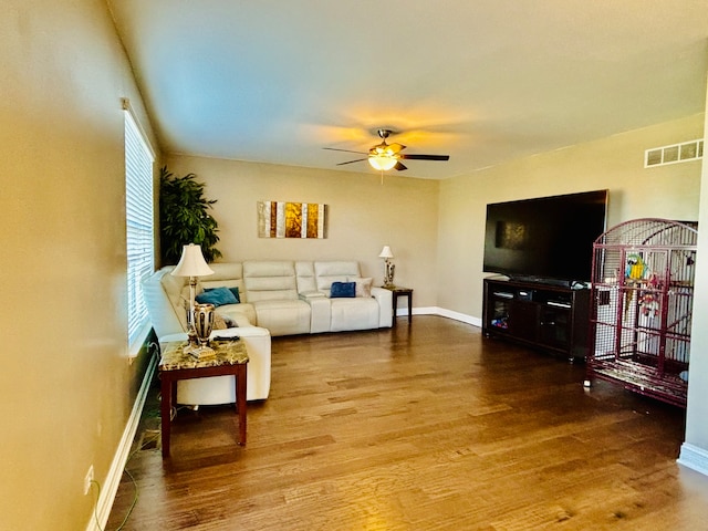 living room with ceiling fan and hardwood / wood-style floors