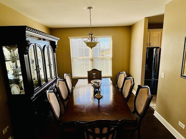 dining space with wood-type flooring