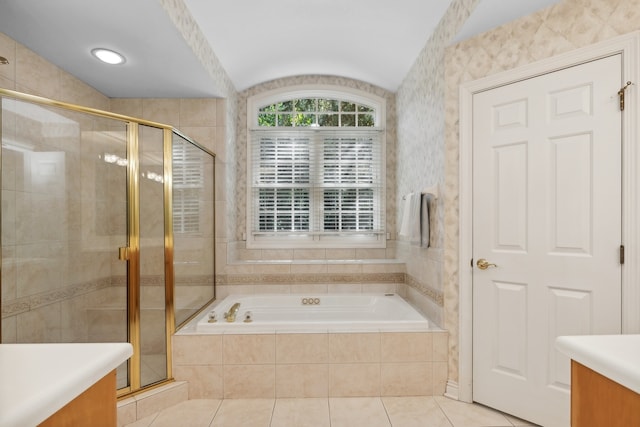 bathroom with independent shower and bath, vanity, tile patterned flooring, and vaulted ceiling