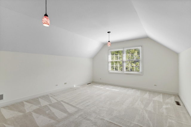 bonus room featuring light colored carpet and vaulted ceiling