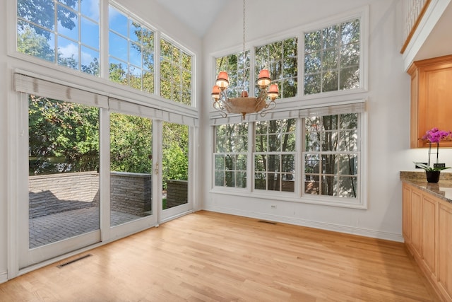 unfurnished sunroom featuring a chandelier