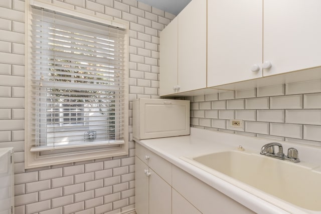 interior space with vanity and tile walls