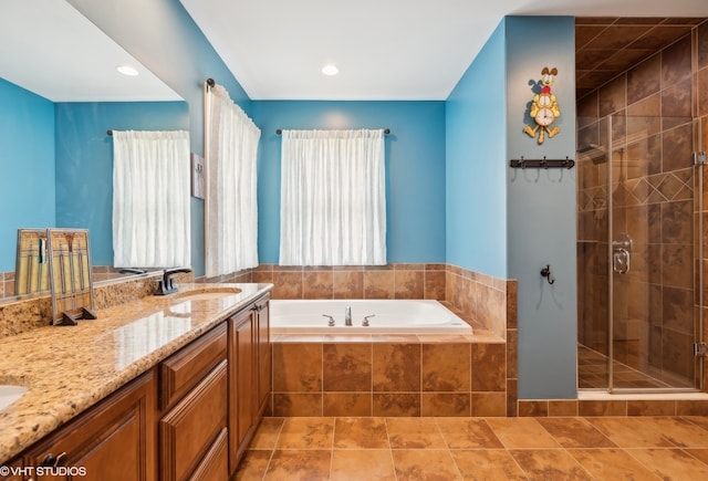 bathroom featuring tile patterned floors, vanity, and independent shower and bath