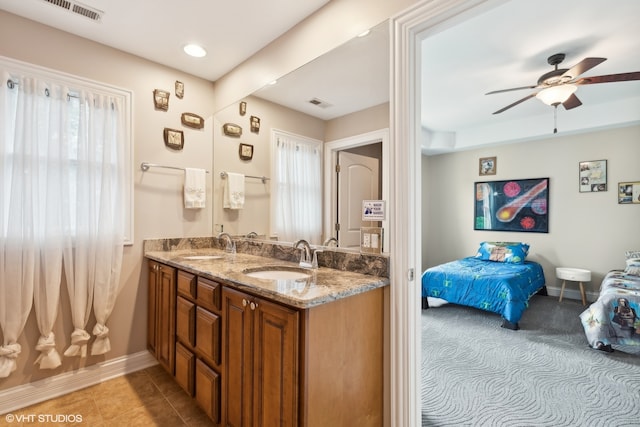 bathroom with tile patterned flooring, vanity, and ceiling fan